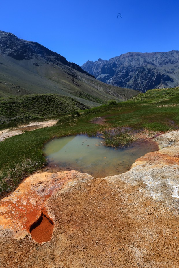 a small pool of water all the way down from the glacier, and on a bed of soil rich in iron